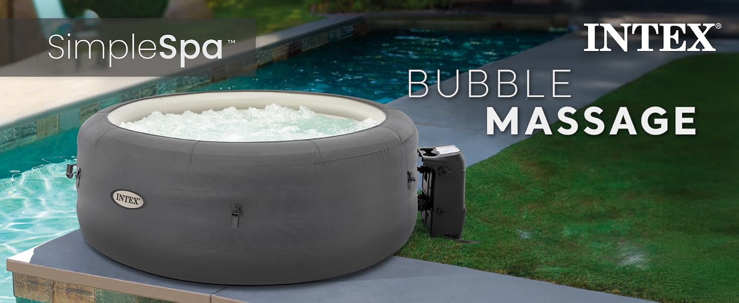 Intex SimpleSpa Bubble Massage hot tub placed beside a pool on a patio in a backyard setting.
