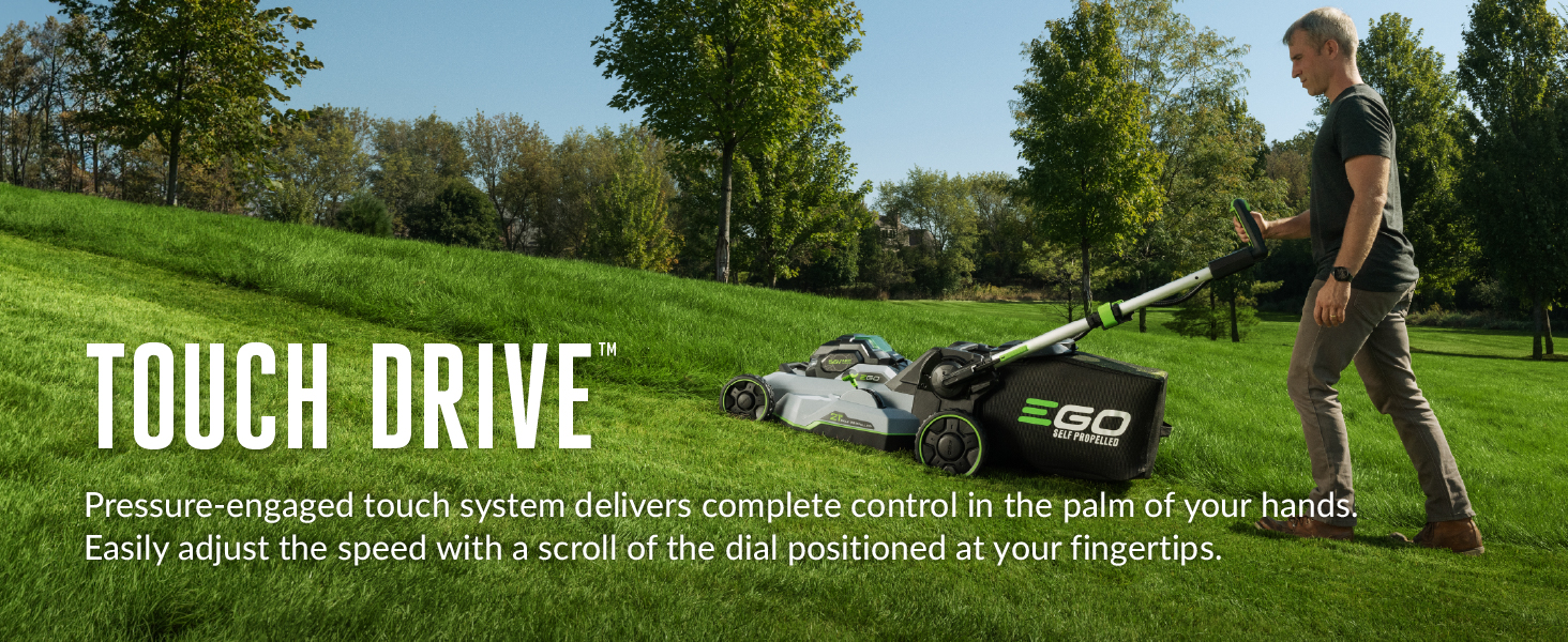 man pushing mower up hill one handed to show touch drive control